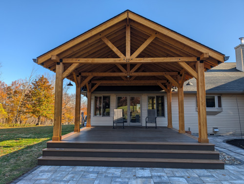 Large outdoor timber frame pavilion or covered patio structure.